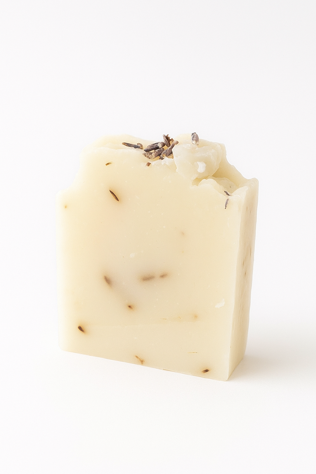 Bar of soap with lavender buds on a white background